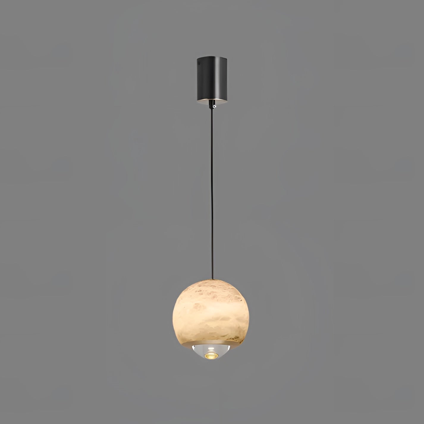 Modern minimalist white spherical pendant light with gold accents hanging from the ceiling, serving as a stylish lighting fixture in a bedroom decor setting.