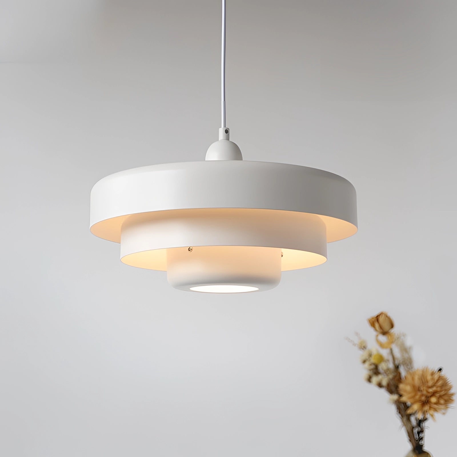 Modern orange pendant light with white accent, showcasing Scandinavian and mid-century contemporary design, hanging from a ceiling.