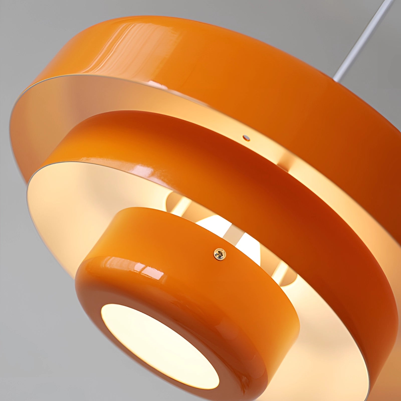 Modern orange pendant light in Scandinavian mid-century contemporary style, featuring amber tones and a sleek design.