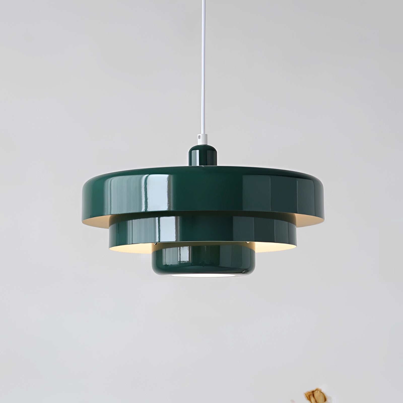 Modern orange pendant light with a cylindrical shape, featuring Scandinavian, mid-century, and contemporary design elements, hanging from the ceiling.
