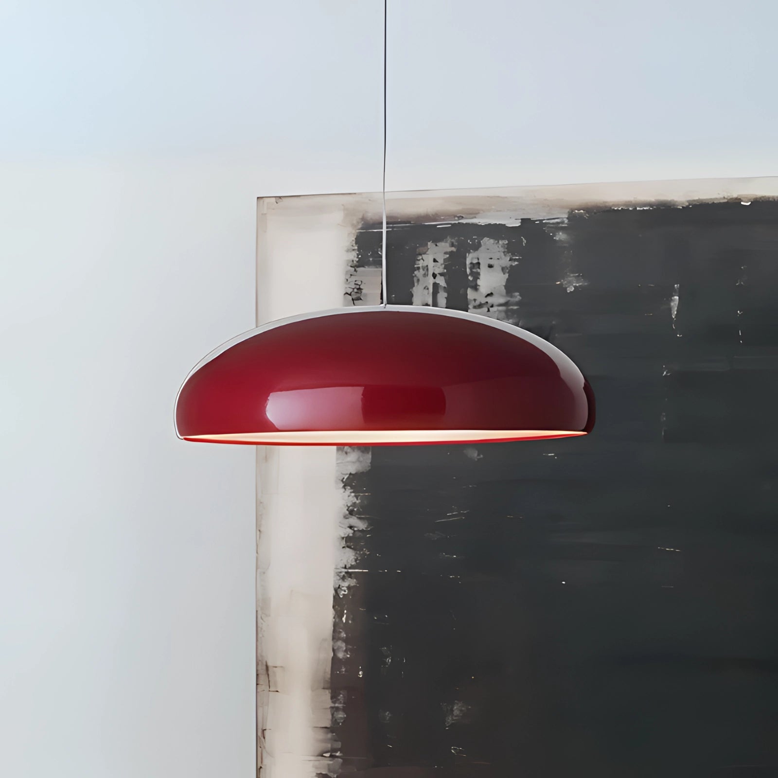 Modern oval pendant light with a minimalist Scandinavian design, featuring a red 60 cm glass shade.