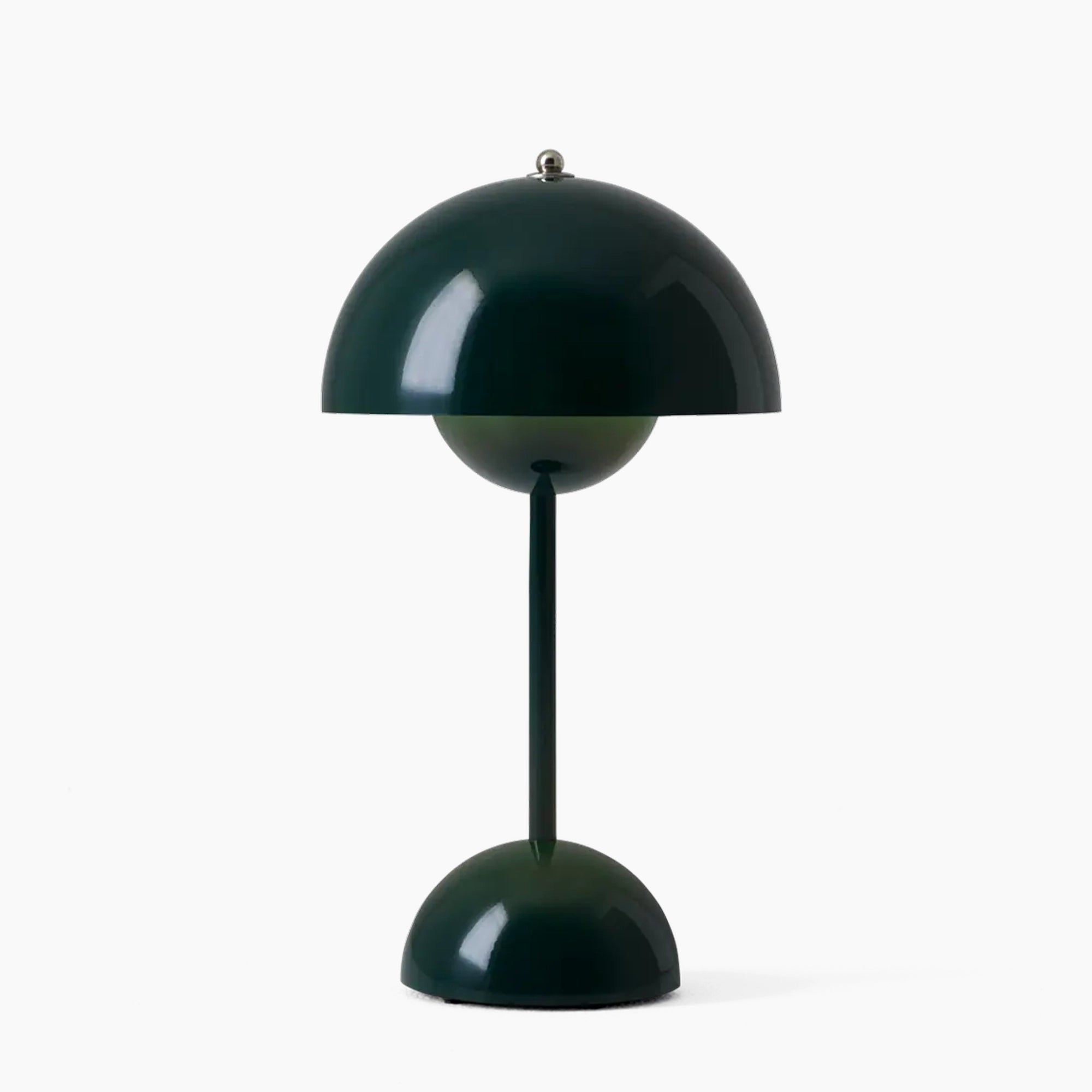 Modern peach table lamp with a dark green finish, featuring a minimalist spherical design, ideal as a stylish lighting accessory.