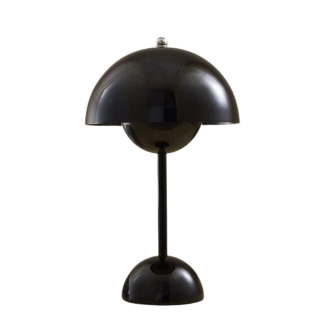 A modern peach table lamp with a minimalist spherical design, featuring a black adjustable metal stand and circular light fixture.