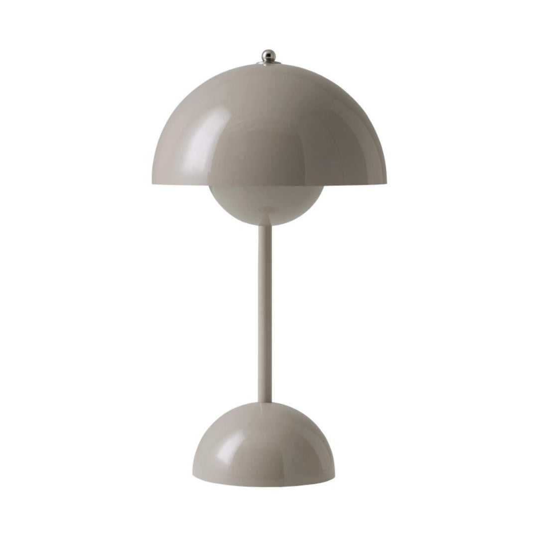 Modern peach table lamp with a minimalist spherical design, featuring an adjustable gray lampshade.