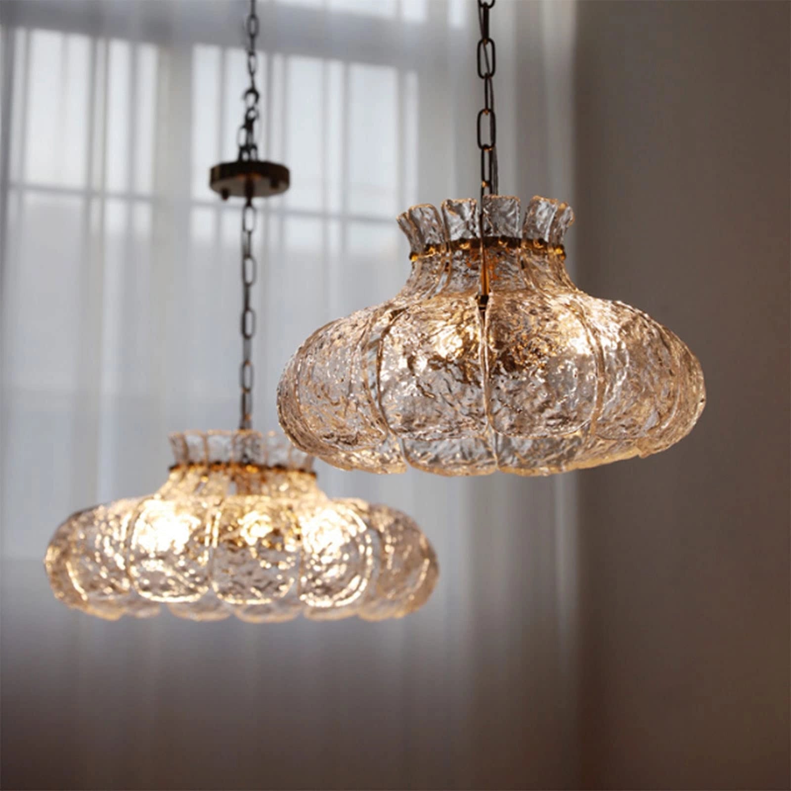 Modern pear-shaped glass chandelier featuring amber-tinted glass with a copper-plated finish, suspended by a gold chain. The chandelier measures 19.7 inches and incorporates natural wood elements for a luxurious lighting effect.