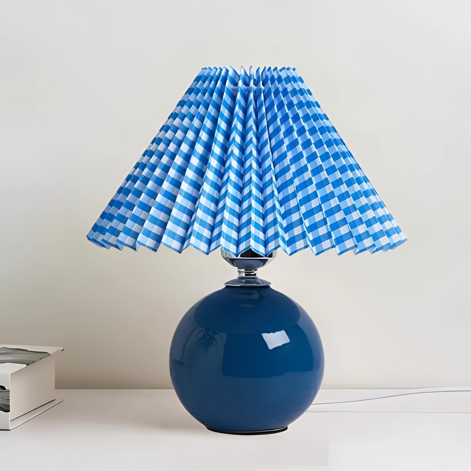 Blue ceramic lamp with a pleated shade in a Scandinavian design style, featuring an electric blue color that contrasts with the azure base, suitable for a table or ceiling fixture.