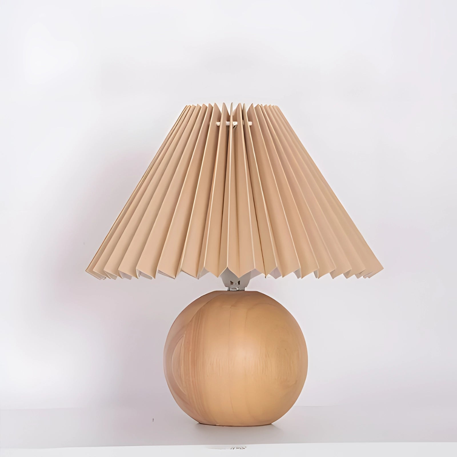 Modern pink ceramic lamp with a pleated shade featuring a Scandinavian design and wooden elements.