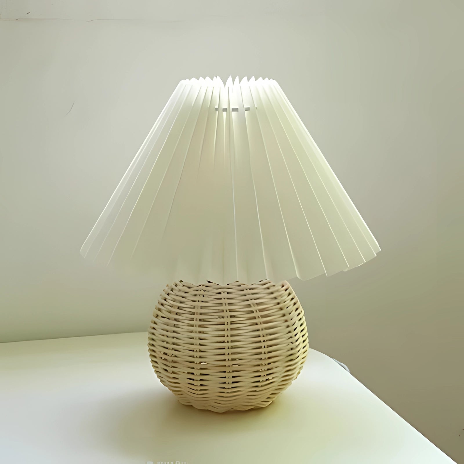 Modern white rattan lamp with a pleated shade featuring Scandinavian design elements, showcasing natural material and intricate patterns.