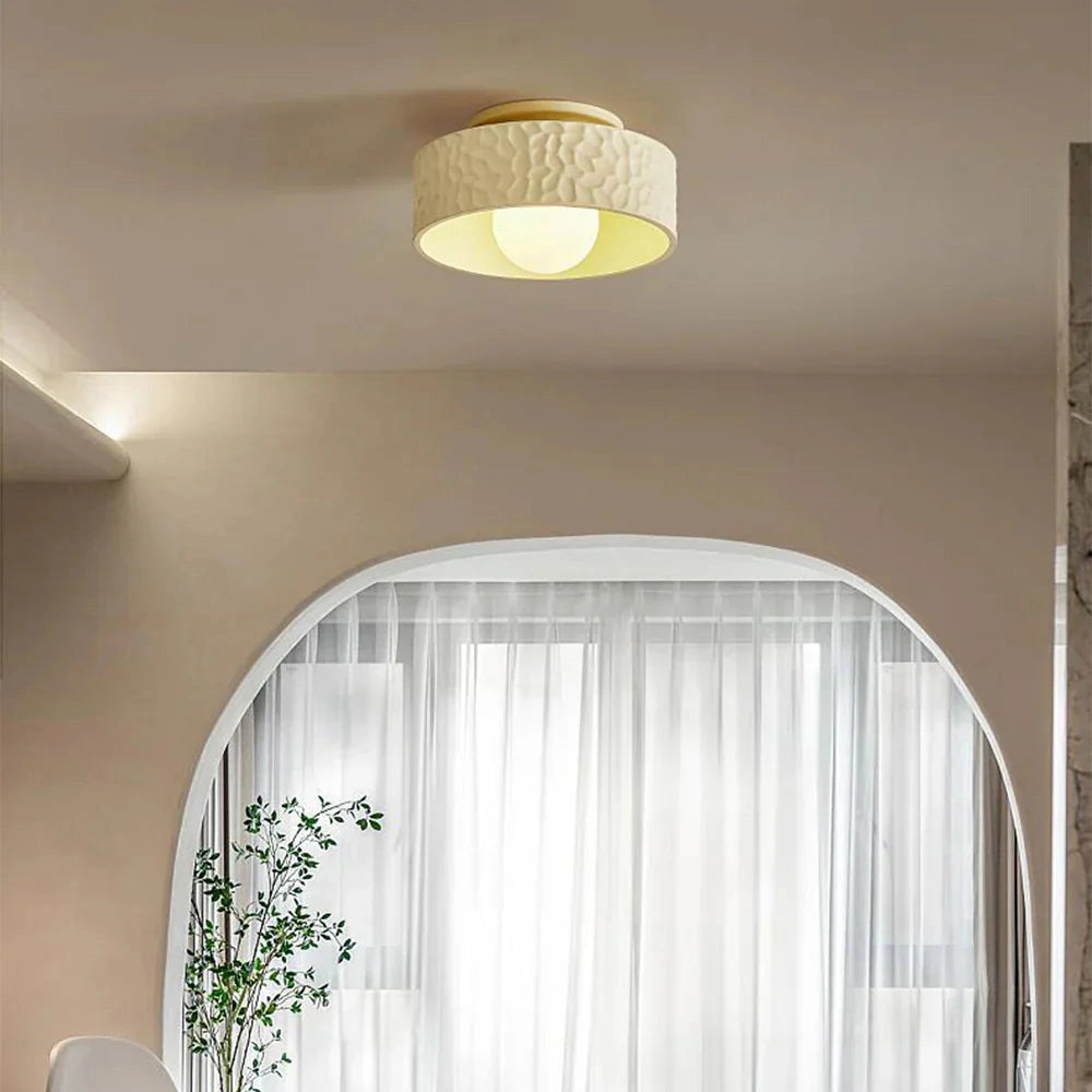 Modern textured circular LED ceiling light fixture with a flush mount design, featuring a white shade and sleek contemporary style, suitable for interior spaces.
