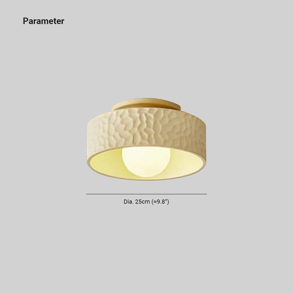 Modern textured circular LED ceiling light fixture mounted flush against a ceiling surface, featuring a sleek design.