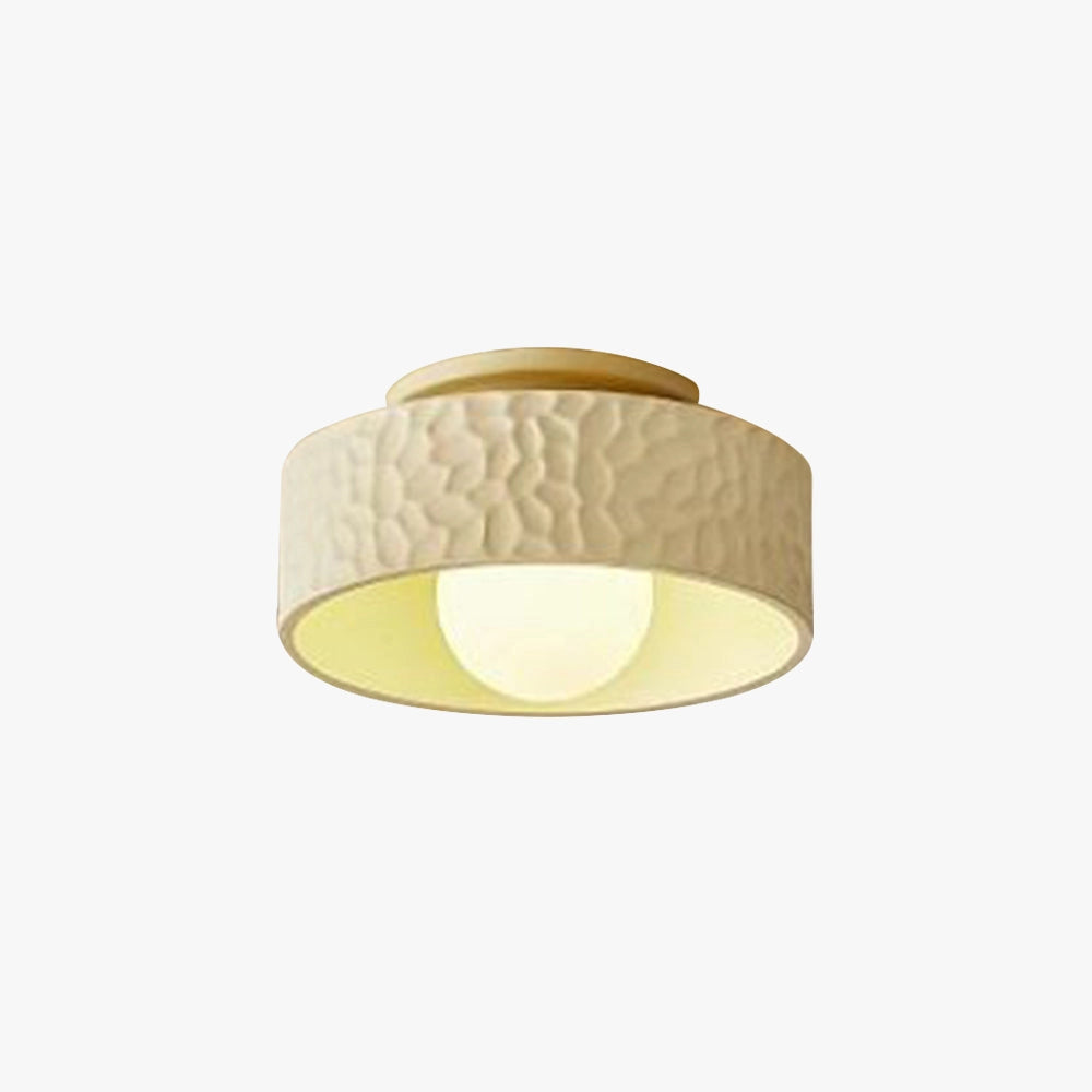 Modern textured circular LED ceiling light with a flush mount design, featuring a metal frame and wood accents.