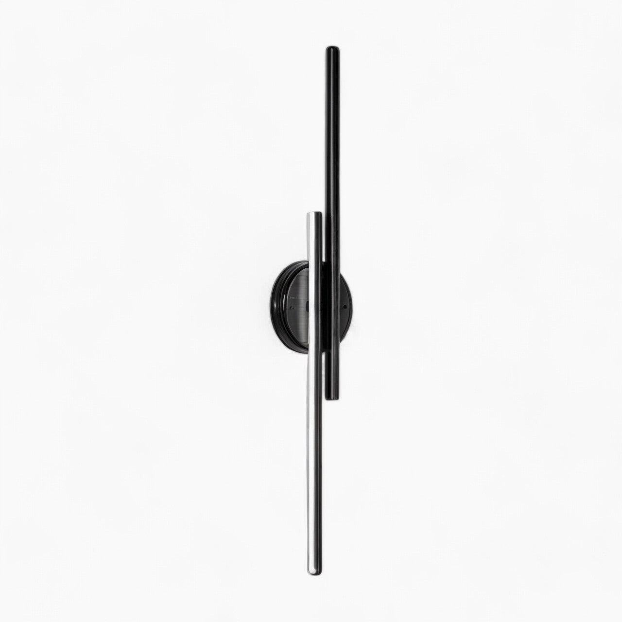 Modern vertical LED wall sconce with a black circular minimalist design, emitting cold white light.
