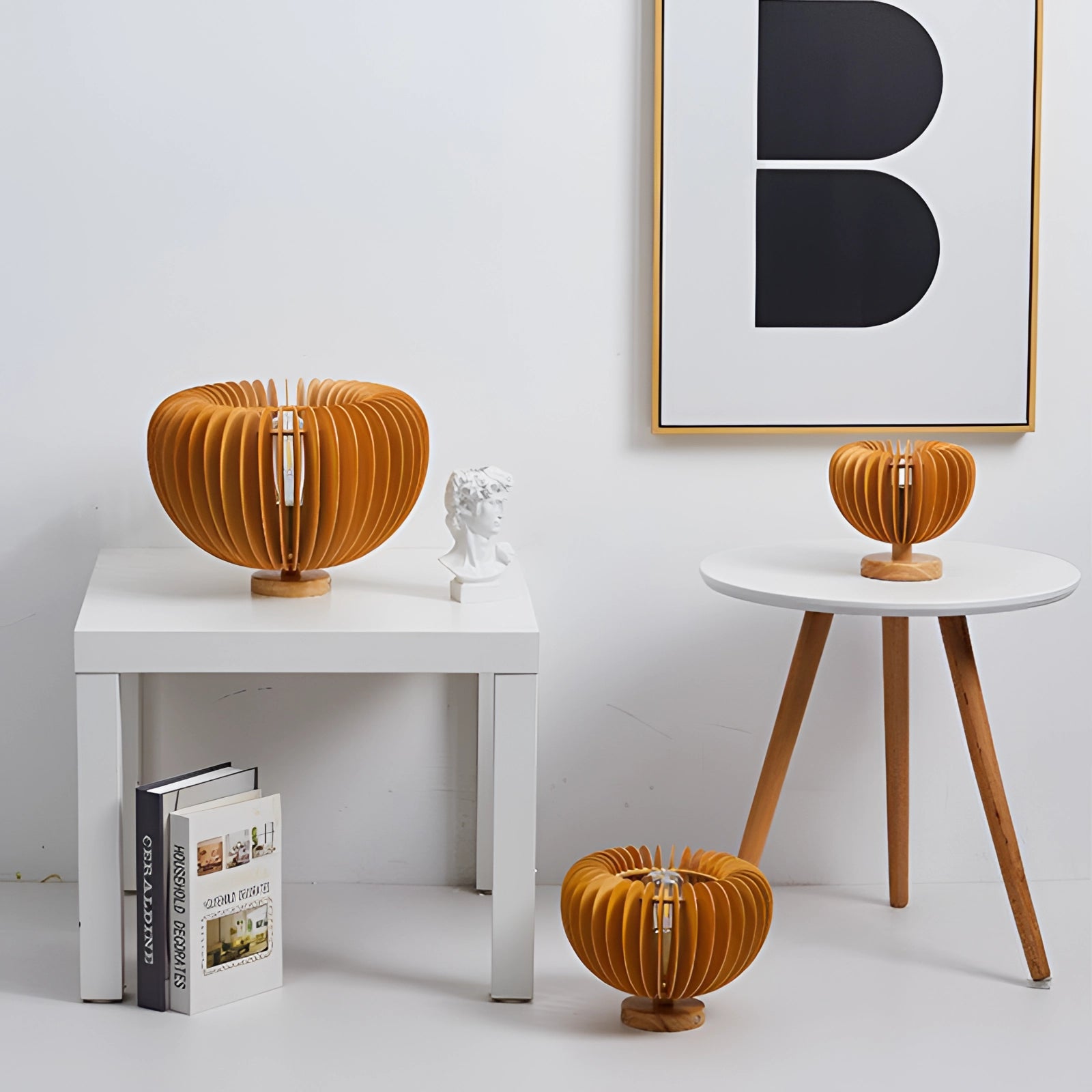 Nordic wooden pumpkin decor on a table, showcasing minimalist Scandinavian design with natural wood and orange tones, set in a stylish interior setting.