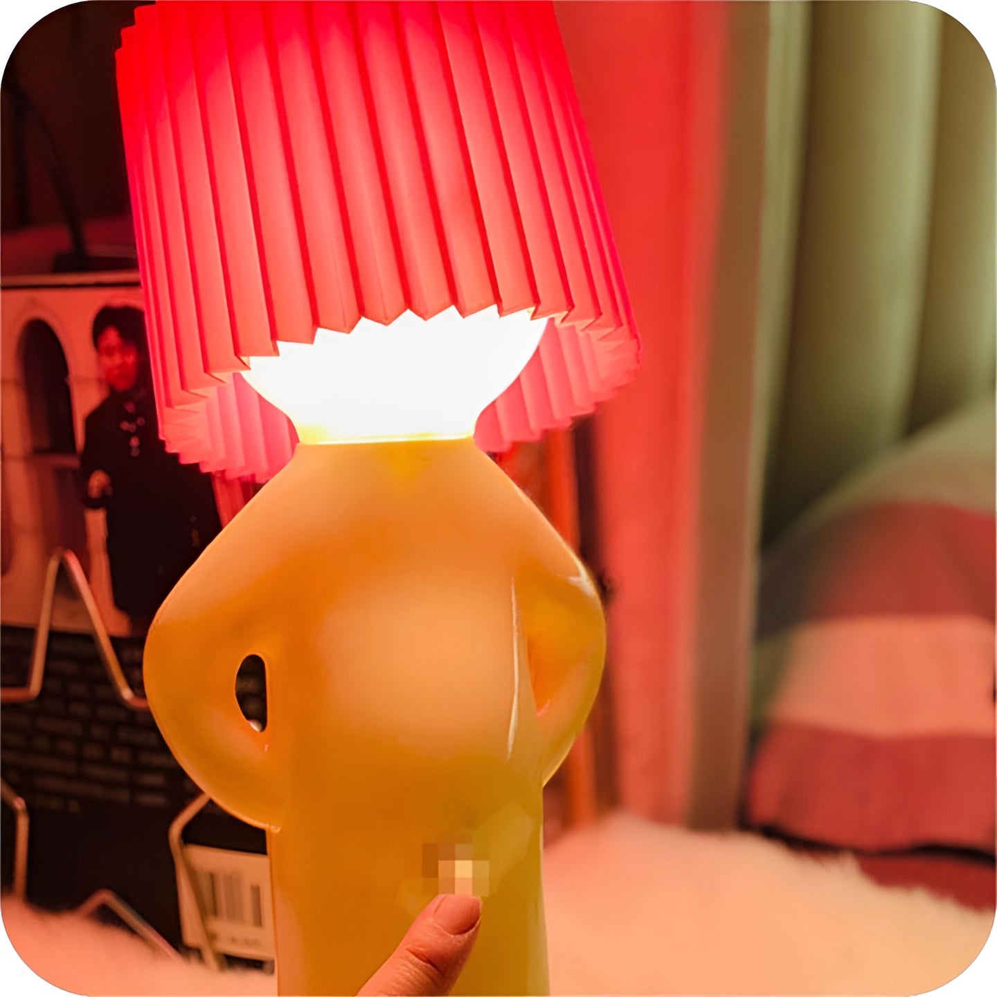 A pink novelty human-shaped table lamp with an artistic and quirky design, serving as a unique accent lighting piece.