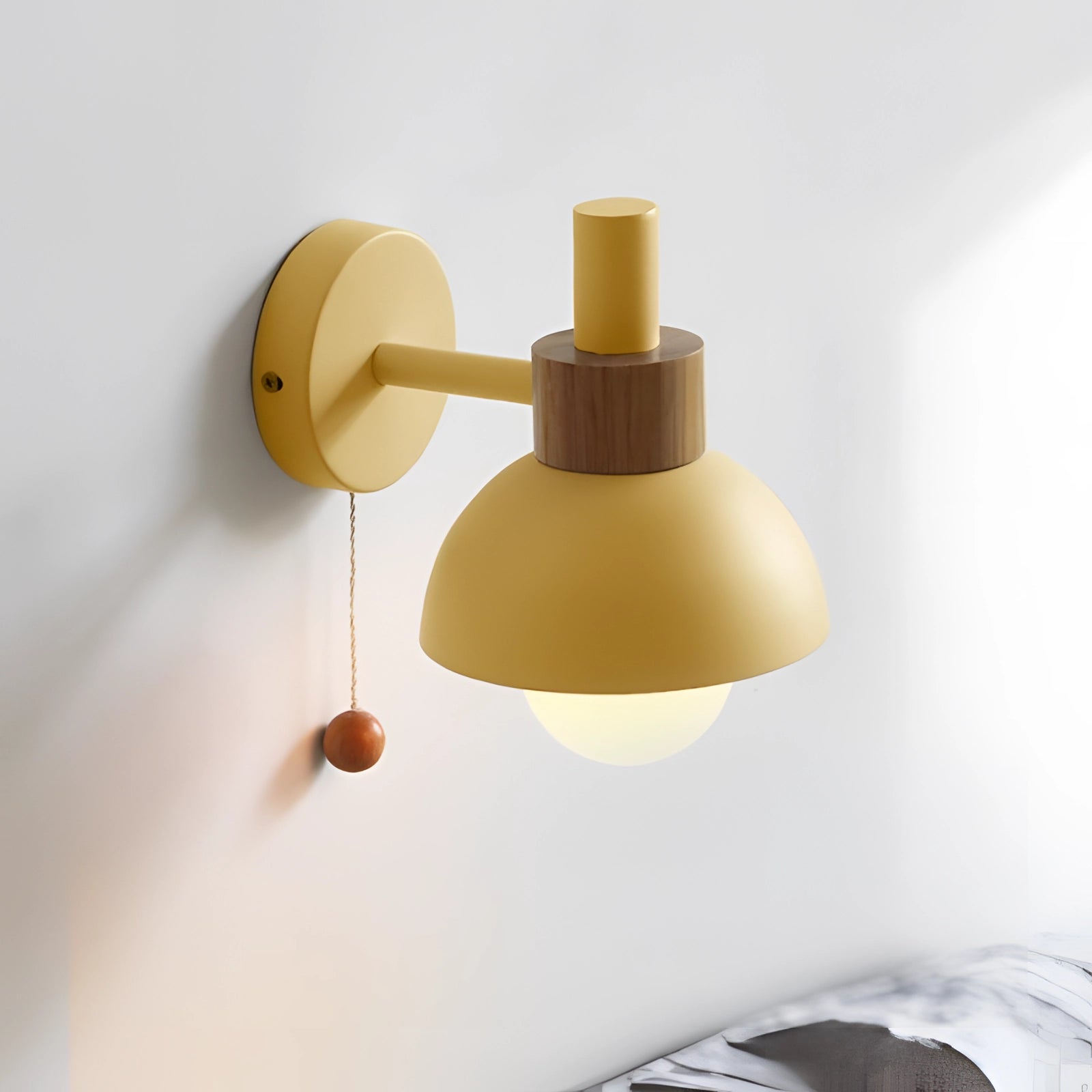 Pastel Scandinavian adjustable wall lamp with minimalist color block design, featuring wood and metal elements, mounted on a wall with a circular base.