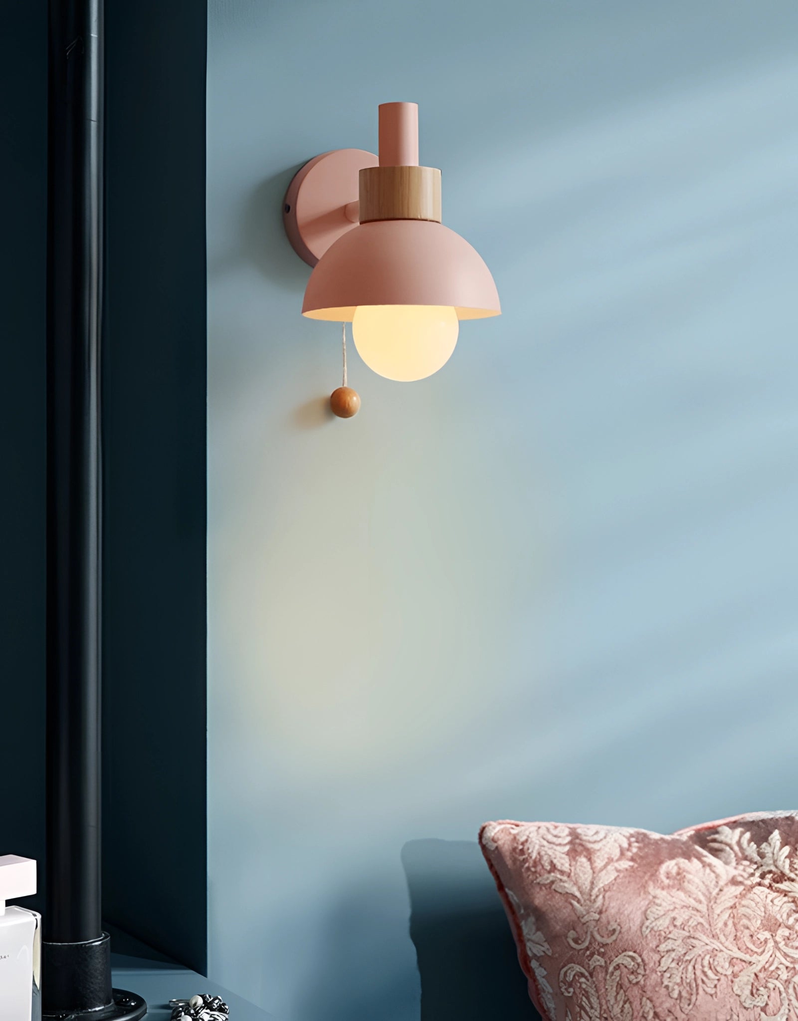 Minimalist pastel Scandinavian adjustable wall lamp with color block design mounted on a wall in a cozy interior setting.