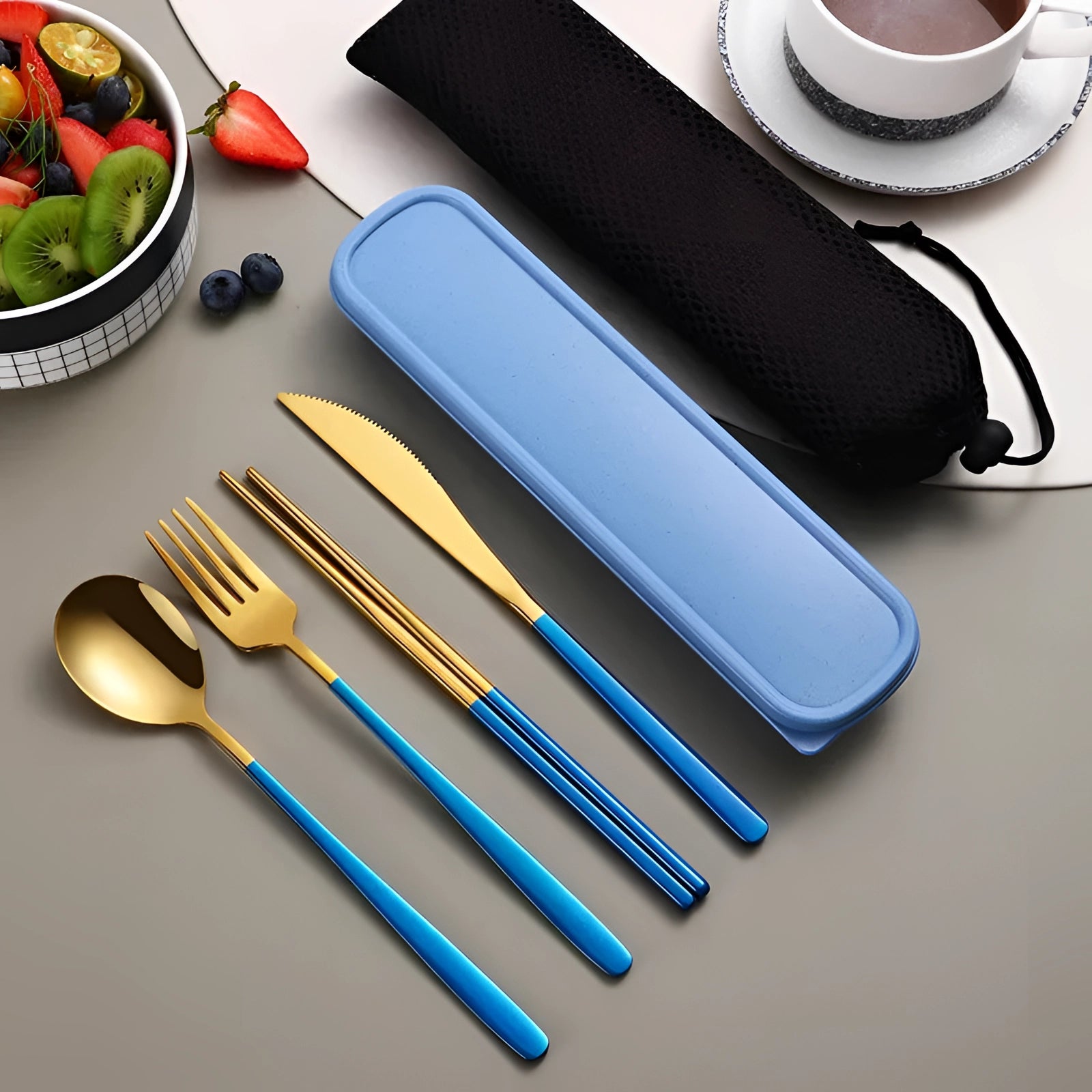 A blue-gold portable eco-friendly stainless steel travel cutlery set including a fork, knife, and spoon, neatly placed on a rectangular case.
