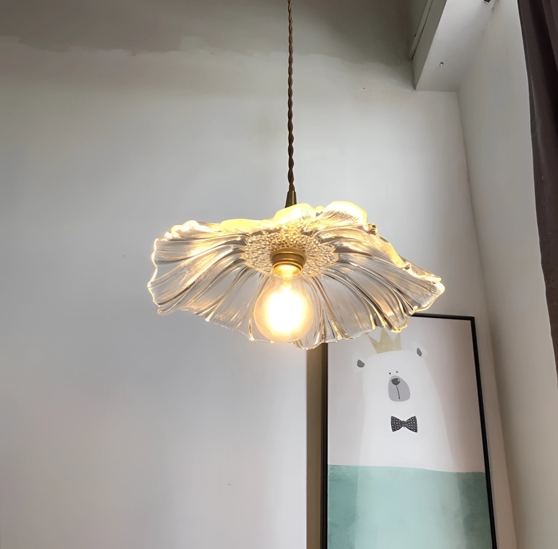 Purple flower-shaped handblown glass pendant light with artistic design, featuring intricate details and mounted on a wooden fixture, displayed as a ceiling fixture.