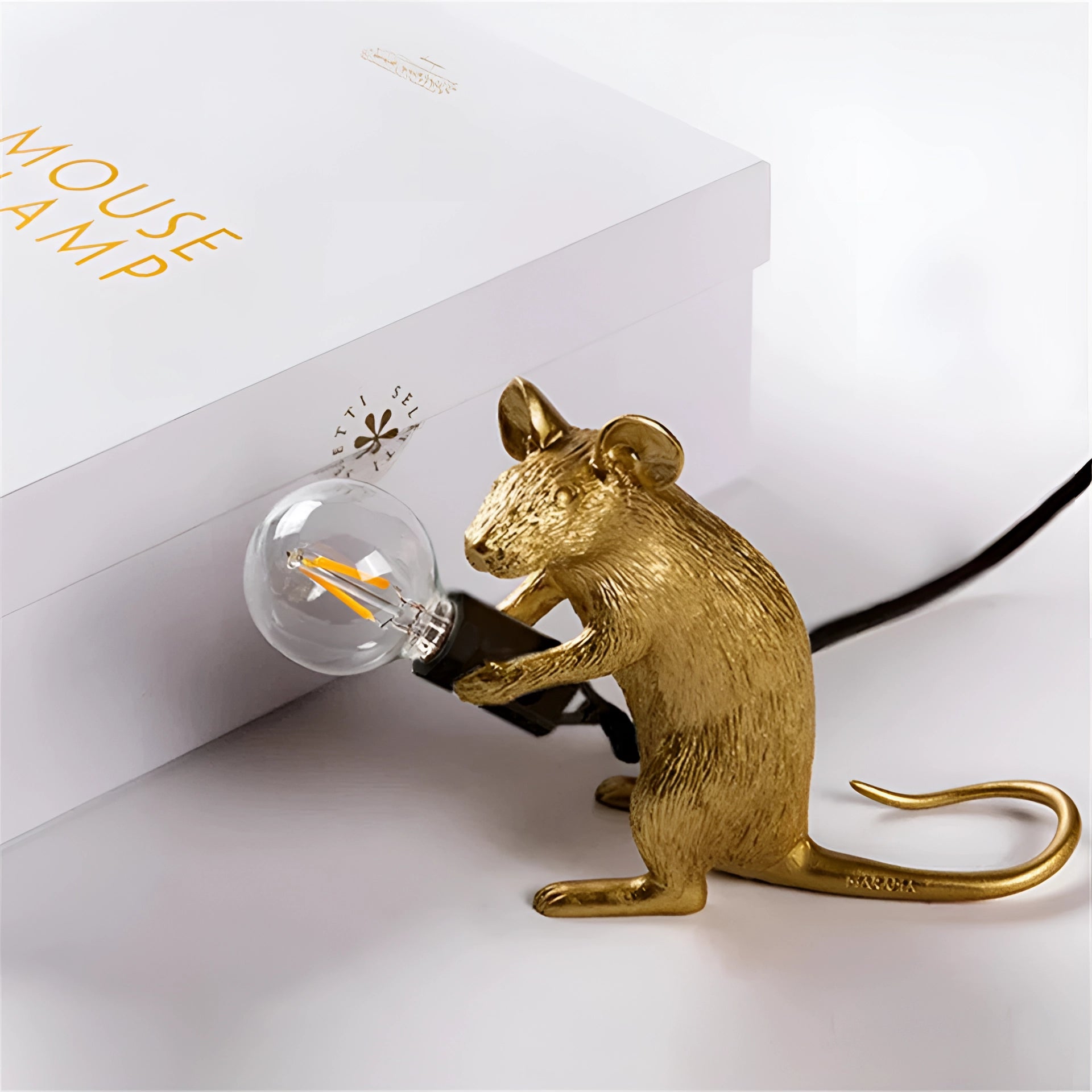 Rat-shaped mouse table lamp with a whimsical animal design, crafted from metal, featuring a detailed tail and serving as unique animal lighting decor.