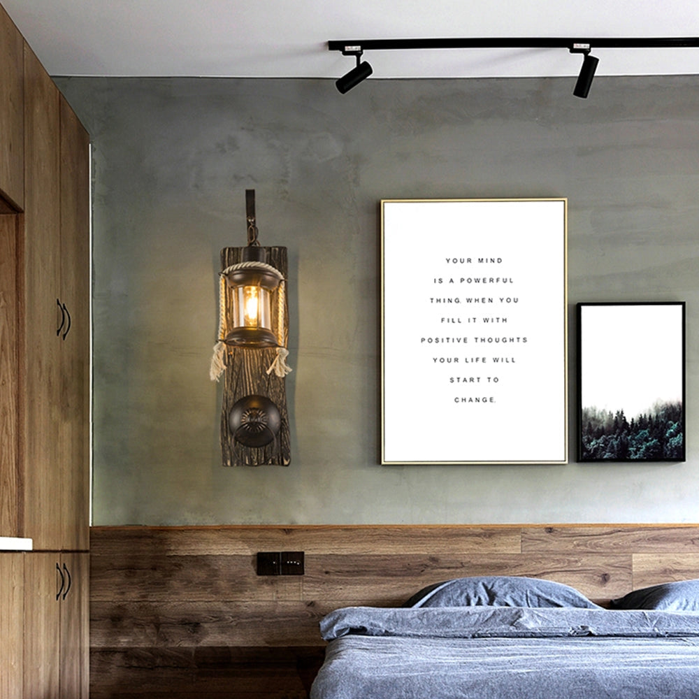 Rustic nautical lantern styled as a vintage sconce placed as part of coastal decor in an interior setting with wood elements, featuring soft ambient lighting against a grey backdrop.