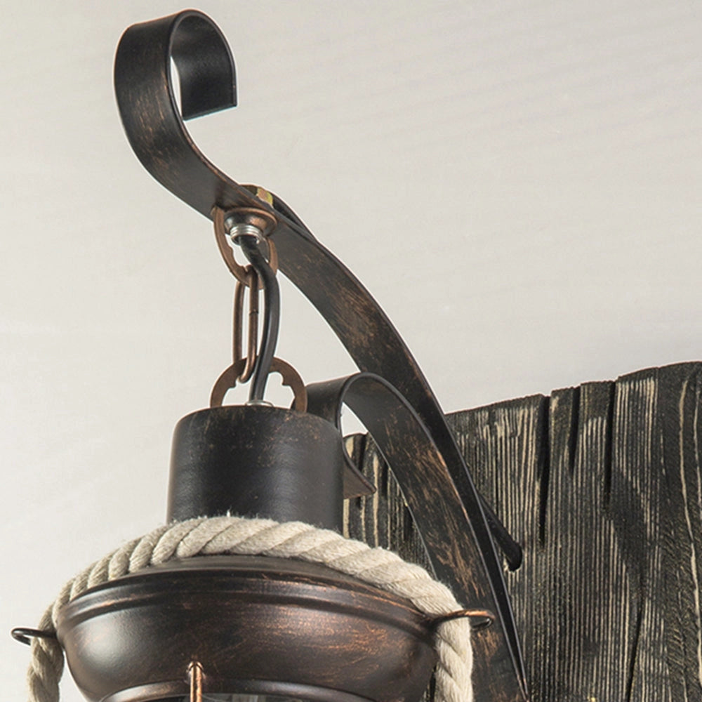 Rustic nautical lantern with a vintage design, featuring wood and metal elements, styled as a coastal decor sconce.