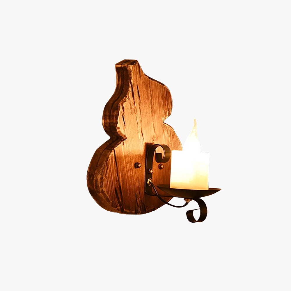 Rustic wall sconce featuring a wooden candle holder and a vintage cello-shaped lamp, showcasing intricate woodwork with a warm wood stain finish.
