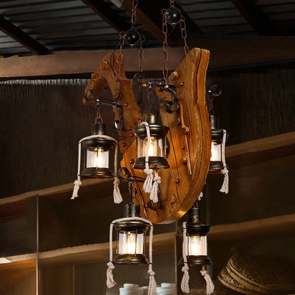 Rustic wooden wheel chandelier with a vintage farmhouse design, featuring metal elements and mounted on a ceiling beam, illuminating a room with its artistic light fixture.