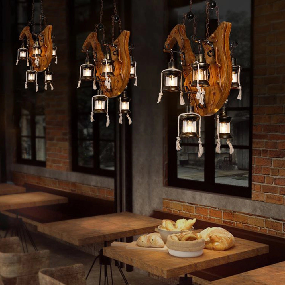 Rustic wooden wheel chandelier with vintage farmhouse design, showcasing intricate woodwork and metal accents, hanging in a cozy dining room setting.