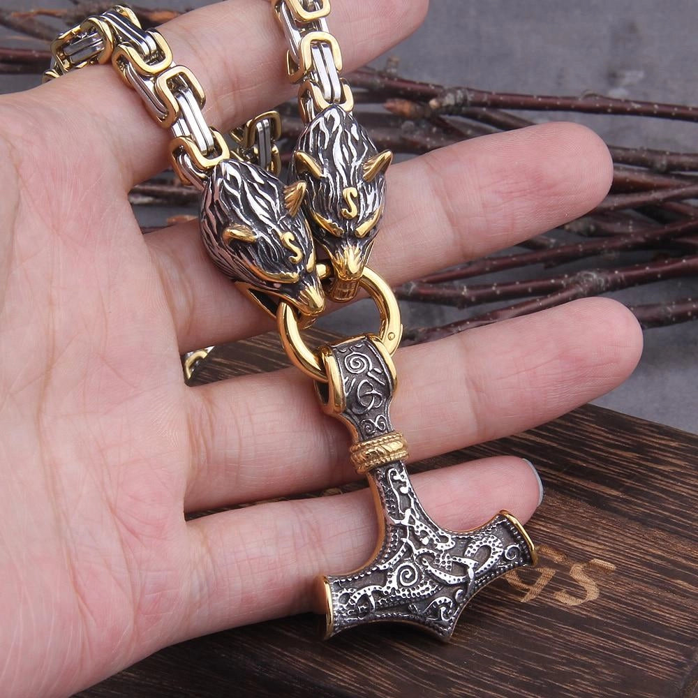 Silver Viking Wolf Head and Mjolnir Pendant resting on a person's open hand, showcasing intricate Norse jewelry design, with detailed craftsmanship visible on the pendant against a backdrop of skin tone and natural lighting.