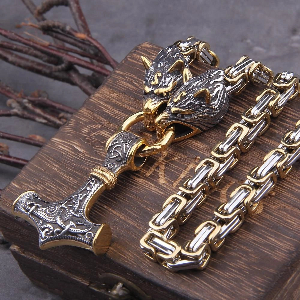 Silver Viking wolf head and Mjolnir pendant featuring intricate Norse designs, crafted from metal and attached to a chain, designed as men's jewelry.