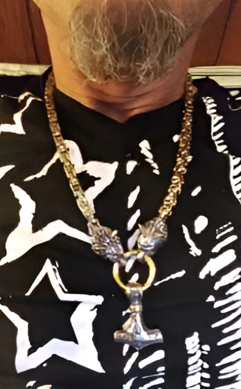 Silver Viking Wolf Head and Mjolnir pendant necklace displayed prominently, showcasing intricate Norse design, suitable for men's fashion and jewelry enthusiasts.