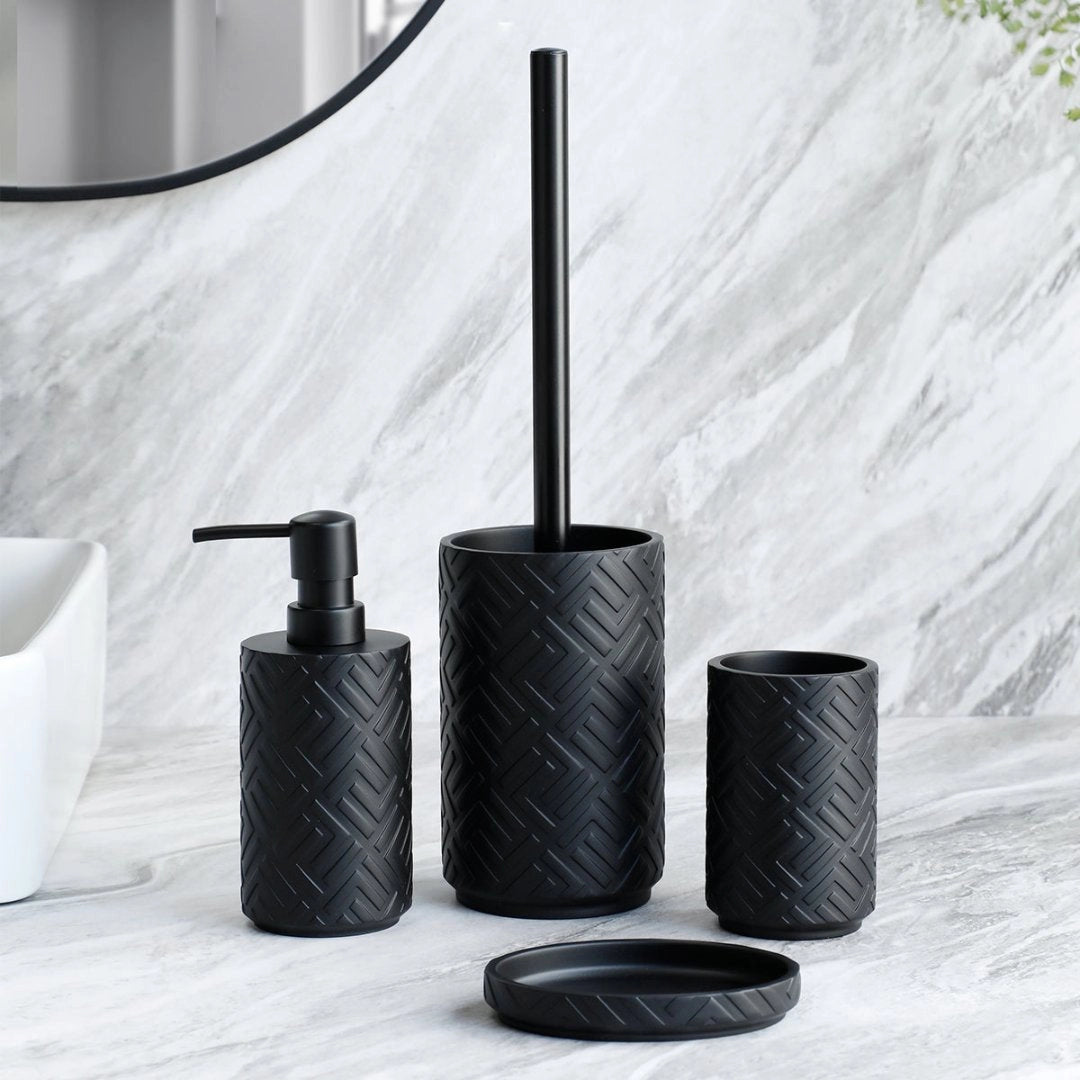 A sleek black bathroom set featuring a soap dispenser and a toothbrush and brush holder with a chevron pattern.