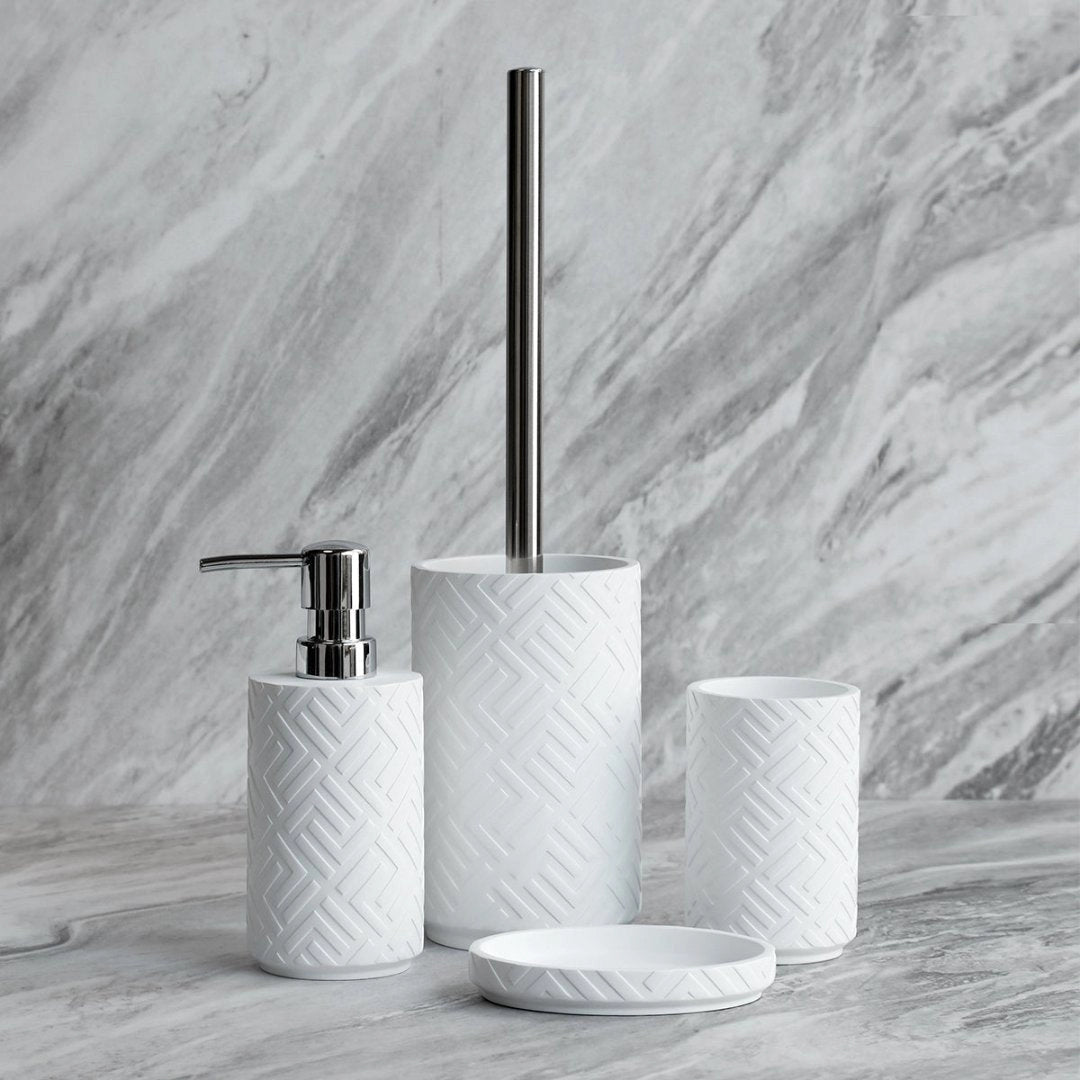 Sleek black and white chevron bathroom set featuring a soap dispenser, toothbrush holder, and brush holder, displayed on a wooden rectangular surface.