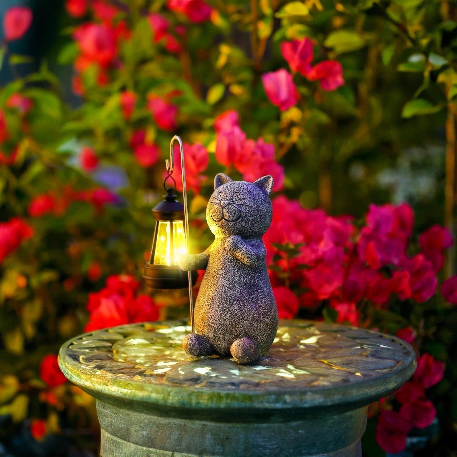 Whimsical cat-shaped solar lantern surrounded by flowers and greenery in a garden setting.