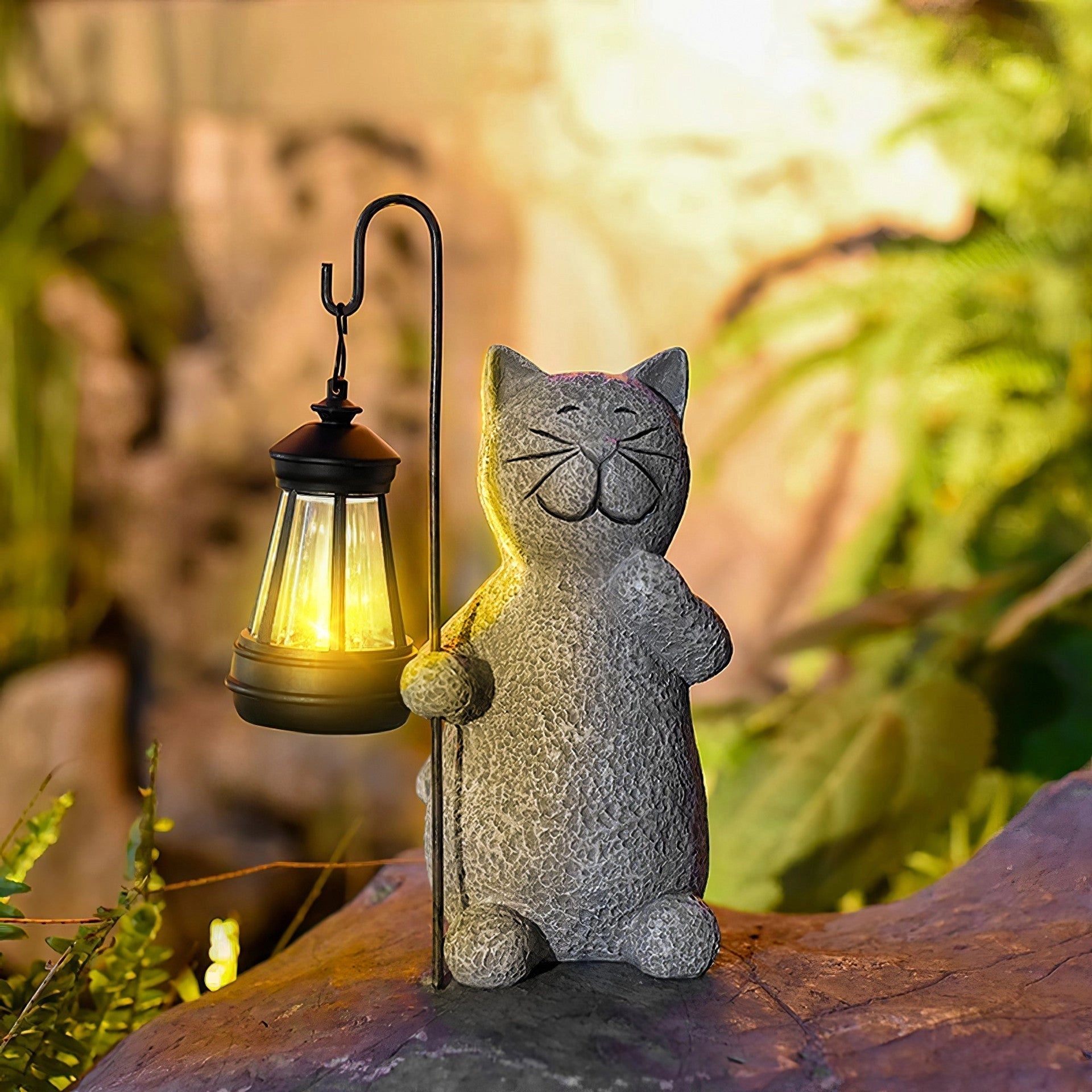 Whimsical solar cat lantern in a garden setting surrounded by plants, featuring a grey cat with prominent whiskers, acting as eco-friendly outdoor decor.