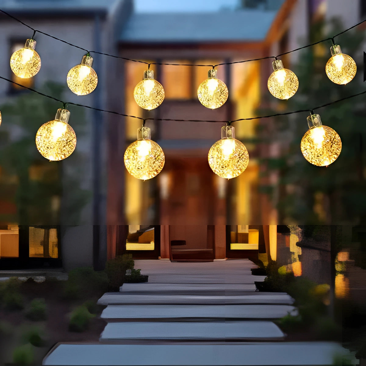 Solar crackled glass globe lights hanging outdoors, showcasing a string of LED bulbs with a waterproof design, ideal for decoration and adding a warm glow to outdoor spaces.