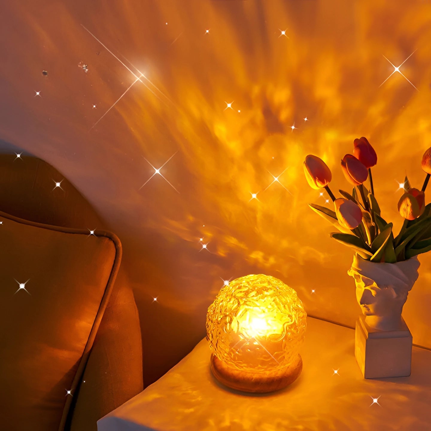 A star-pattern lamp with a celestial mood projector feature, casting a warm amber glow on a table, creating a romantic night atmosphere. The lamp's design includes star-shaped patterns, diffusing light in various tints and shades of orange, reminiscent of a serene night sky.