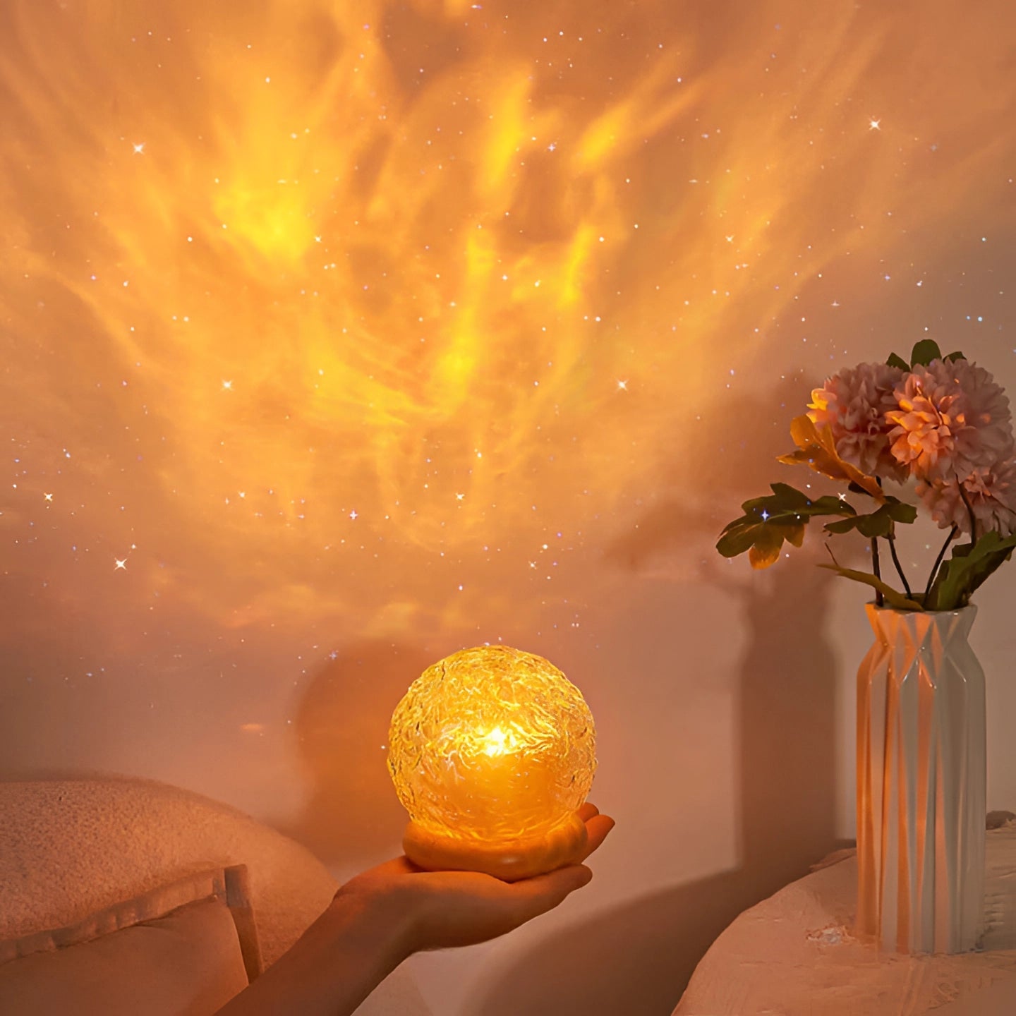 Star-pattern lamp projecting celestial mood lighting with an orange and amber glow, creating a romantic night atmosphere.