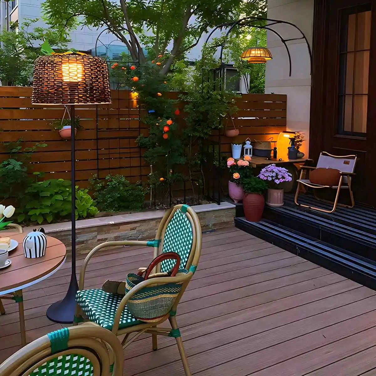 Tall floor lamp with mesh shade in sleek black industrial design, placed next to a potted plant and modern furniture in a stylish interior setting.