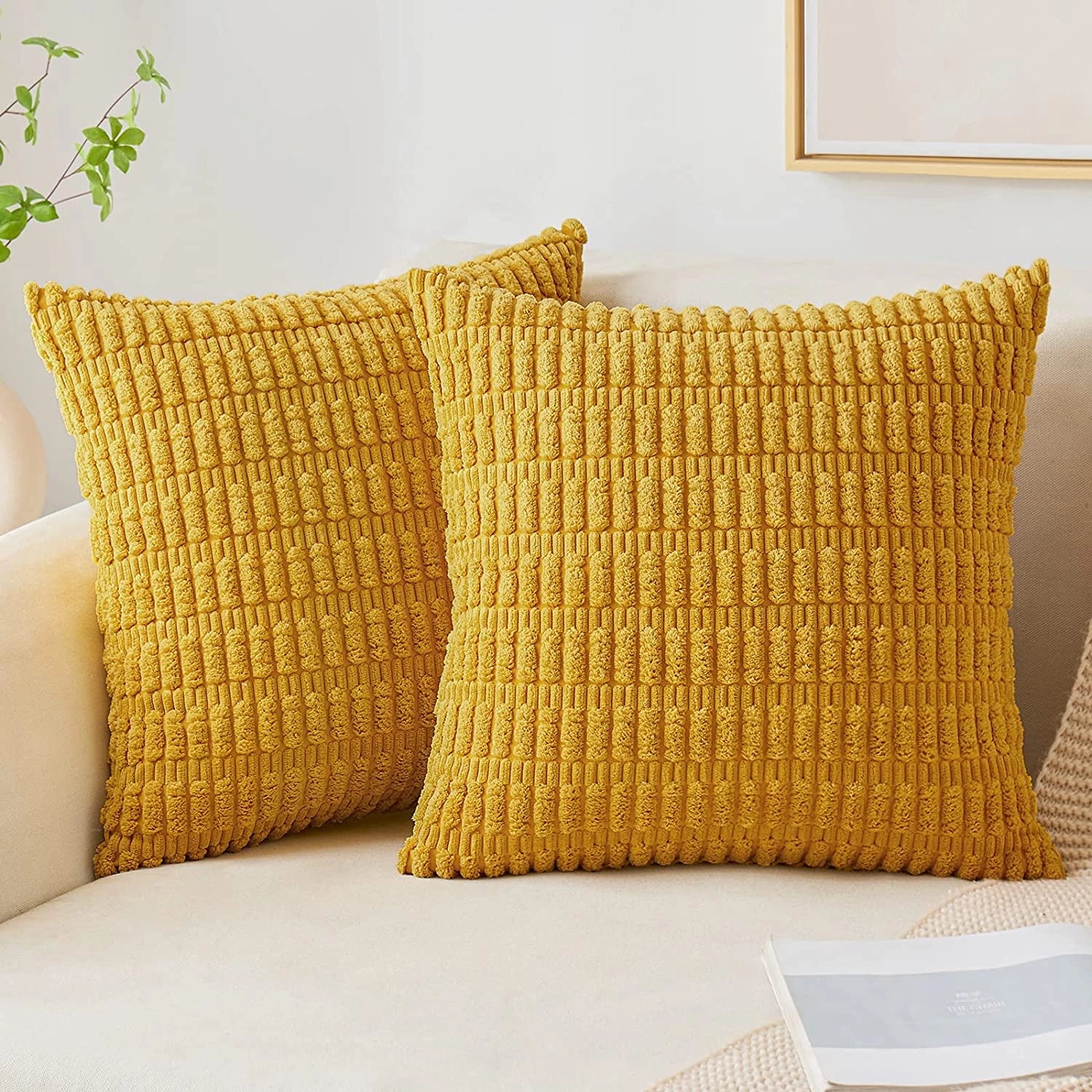 Textured mustard corduroy cushions on a beige sofa, featuring a set of two 45x45cm lumbar pillows, enhancing comfort and decor in a living room setting with wooden furniture and flooring.