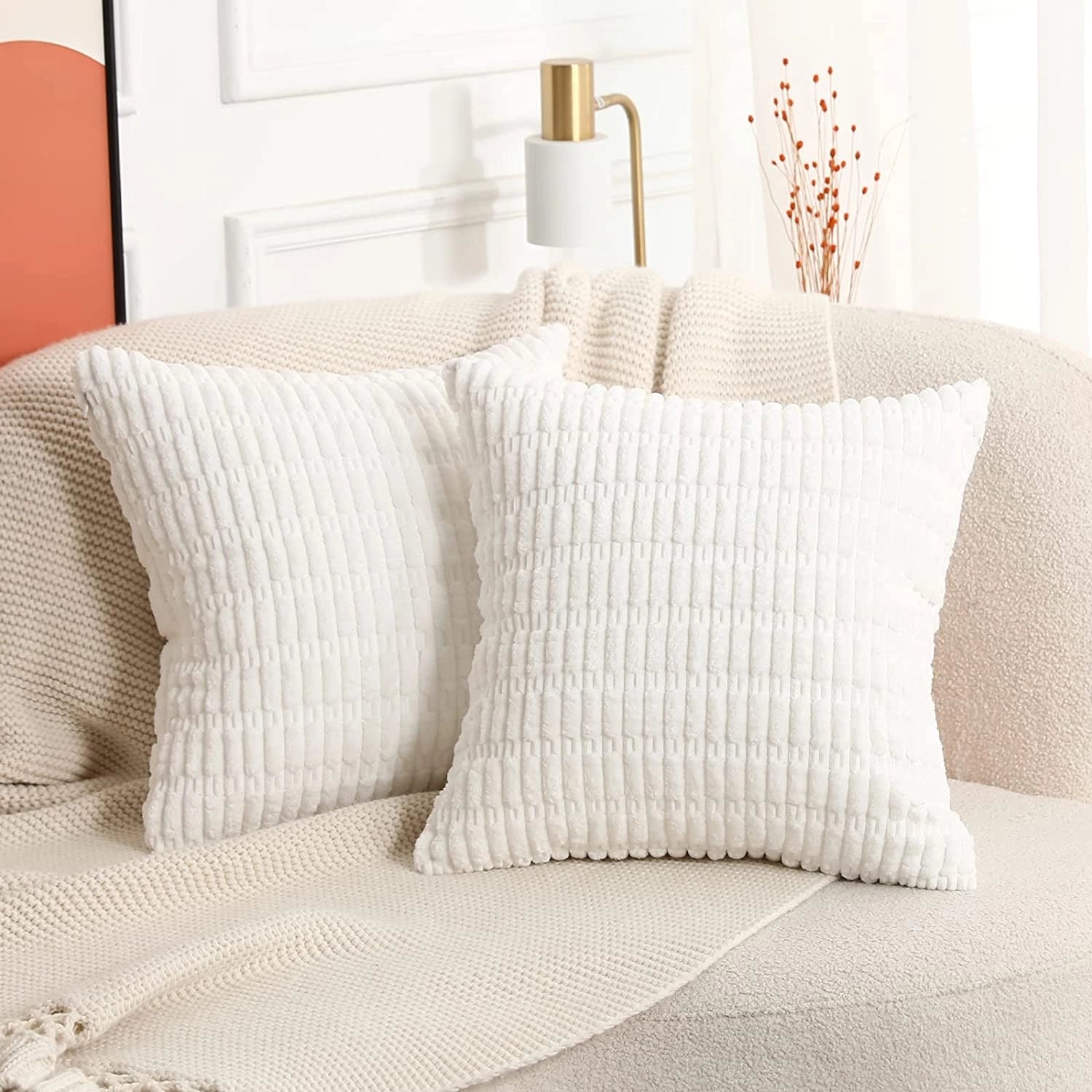 Pair of white textured corduroy cushions, size 45x45cm, placed on a beige sofa, enhancing the interior design with comfort and style.