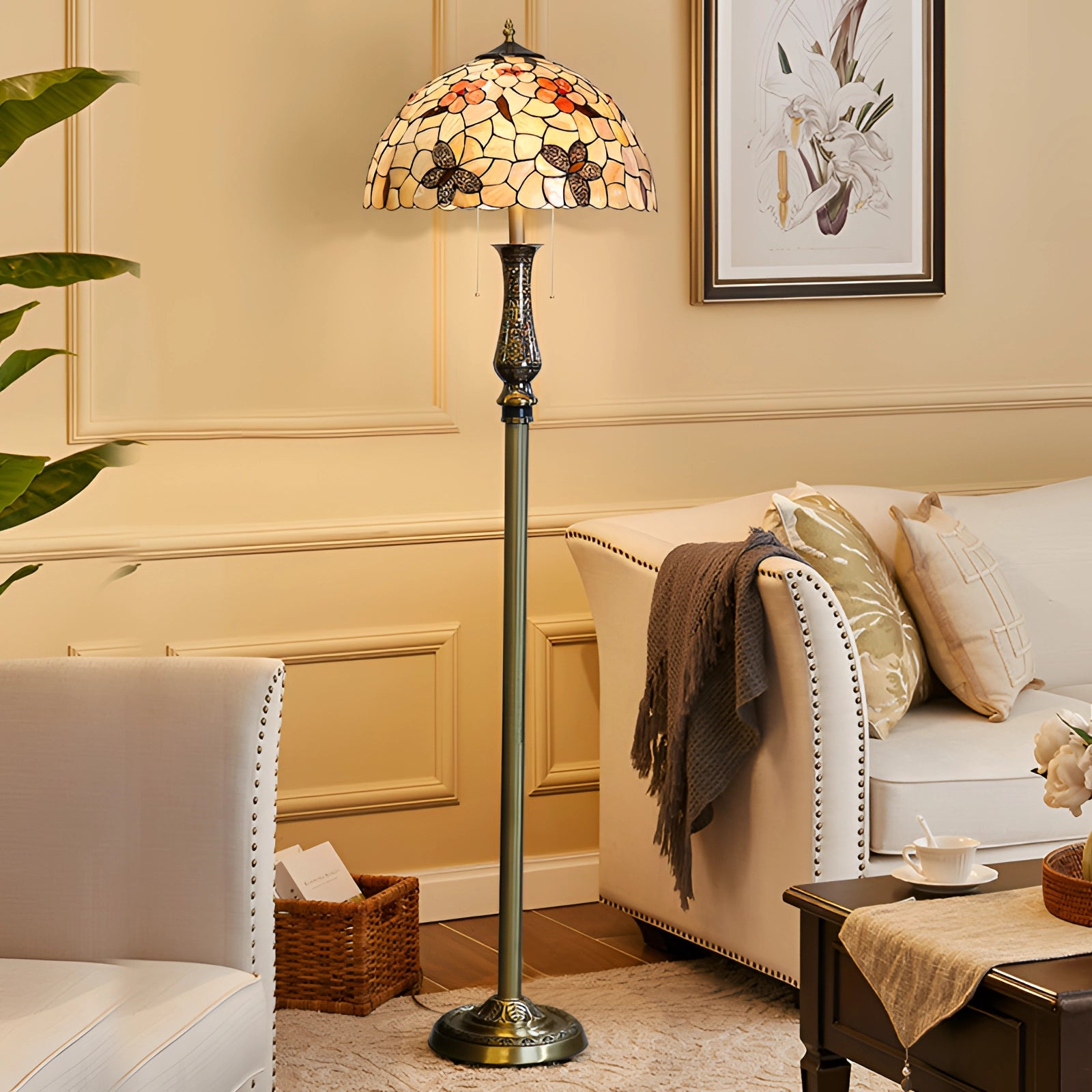 Tiffany-style dragonfly stained glass floor lamp with a brass pole, featuring intricate patterns in shades of yellow and beige, standing in a stylishly decorated interior space with wooden furniture elements.