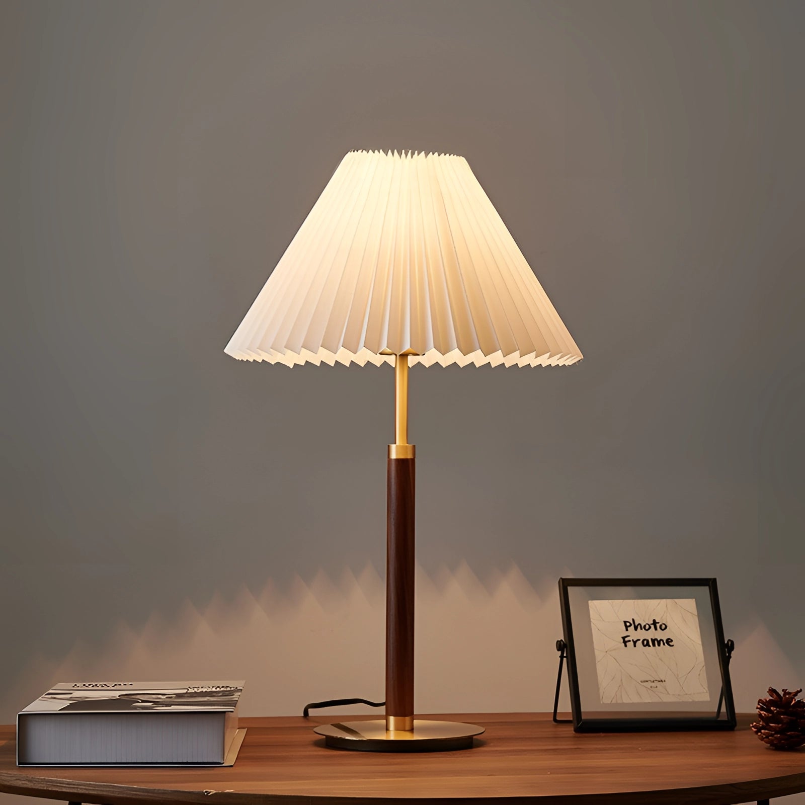 Vintage brass table lamp with adjustable height, featuring a pleated shade in a mid-century modern design.