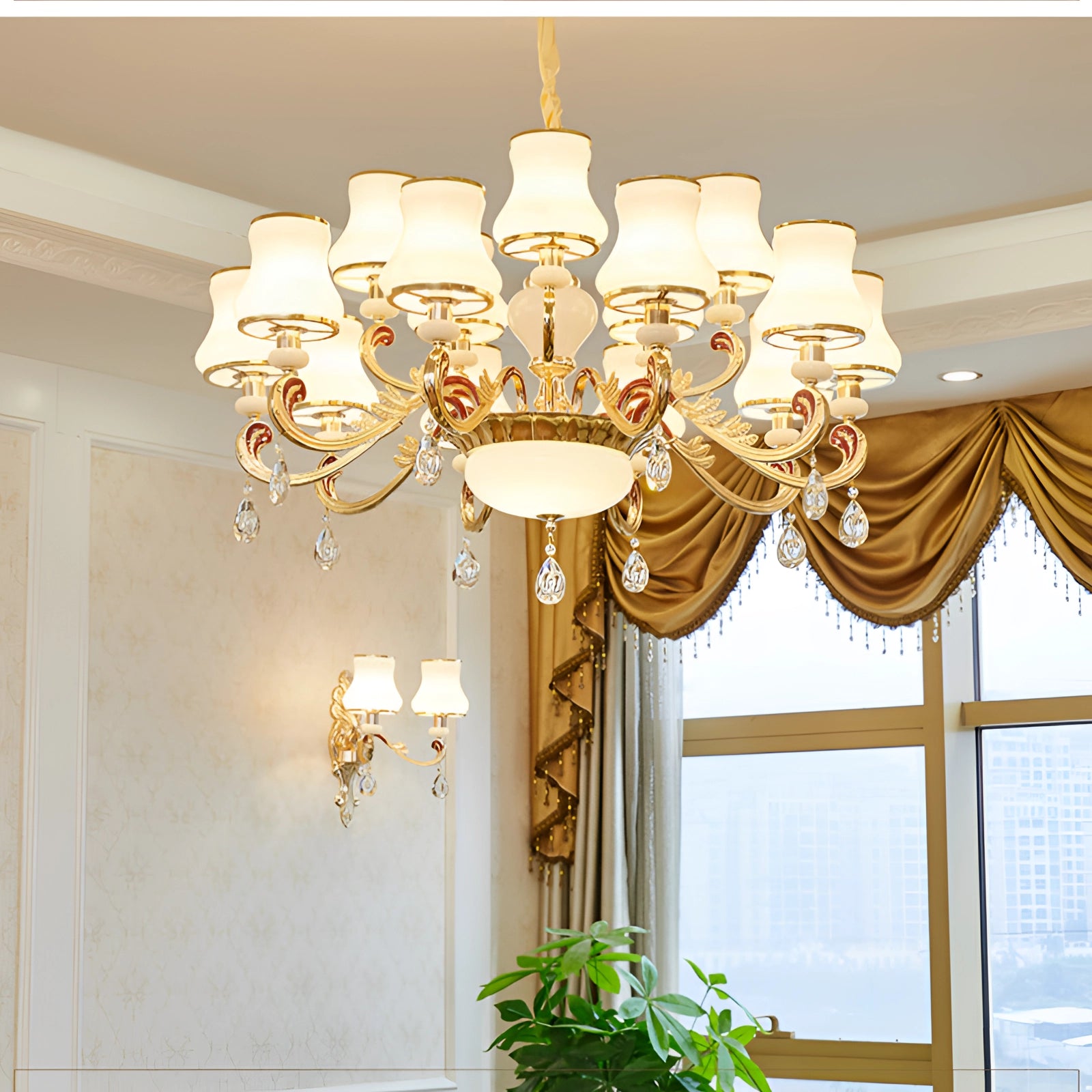 Vintage brass pendant light with an antique winged chandelier design featuring 15 lights, hanging in a room with houseplants and large windows, complementing the interior decor.