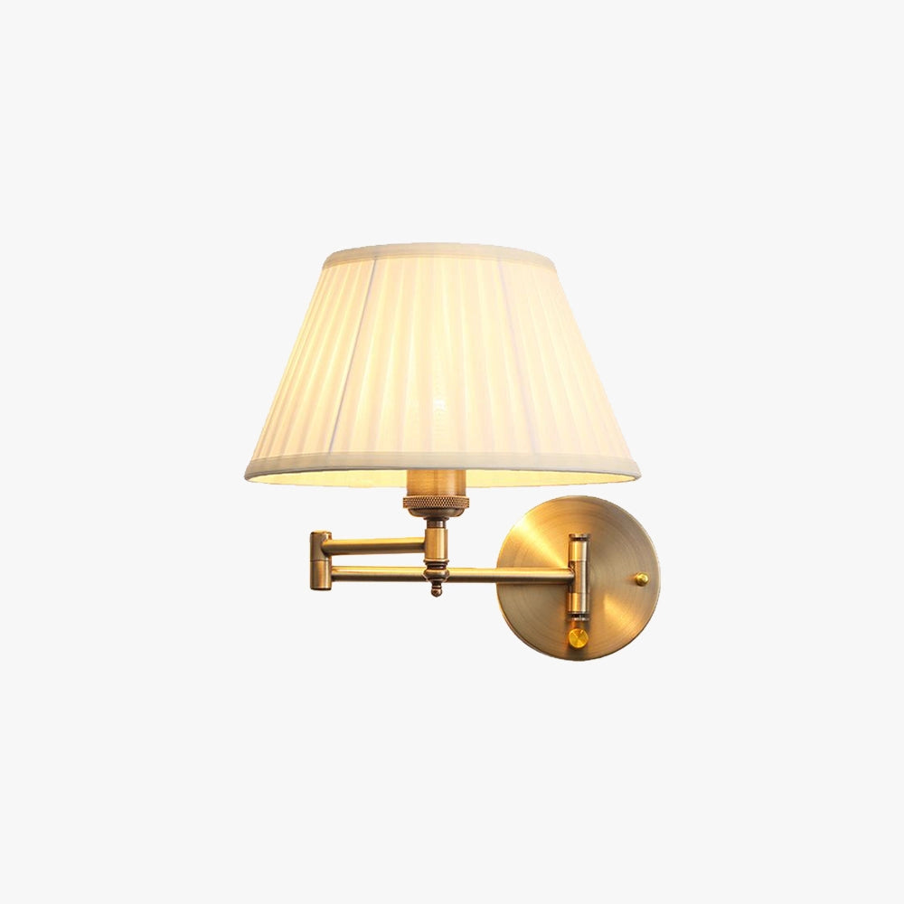Vintage brass wall sconce with pleated shade and adjustable arm mounted on a wooden wall, providing soft lighting with its elegant design.