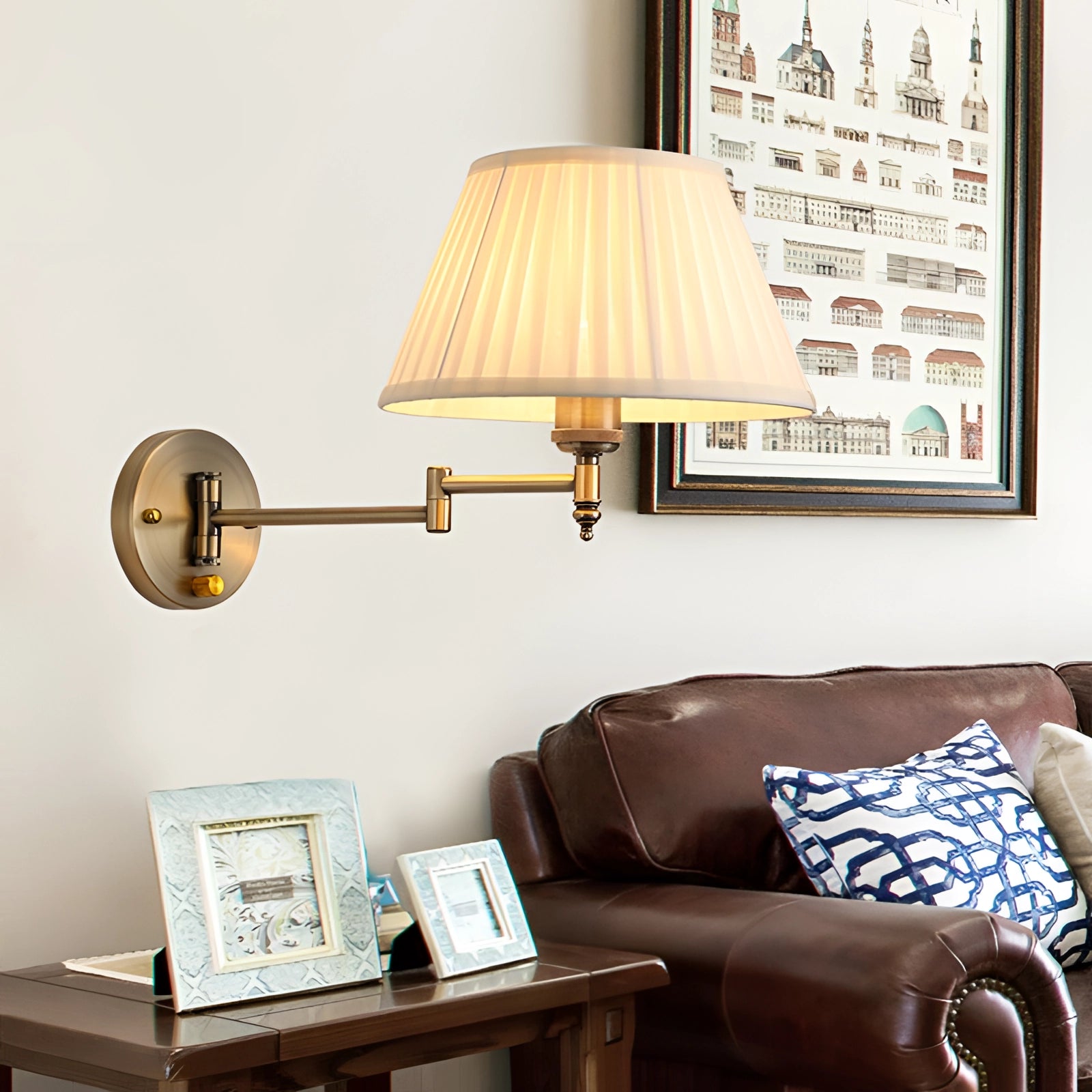 Vintage brass wall sconce with a pleated white shade and adjustable arm, mounted on a wooden wall in a stylish living room setting, enhancing the interior design with its elegant lighting fixture.