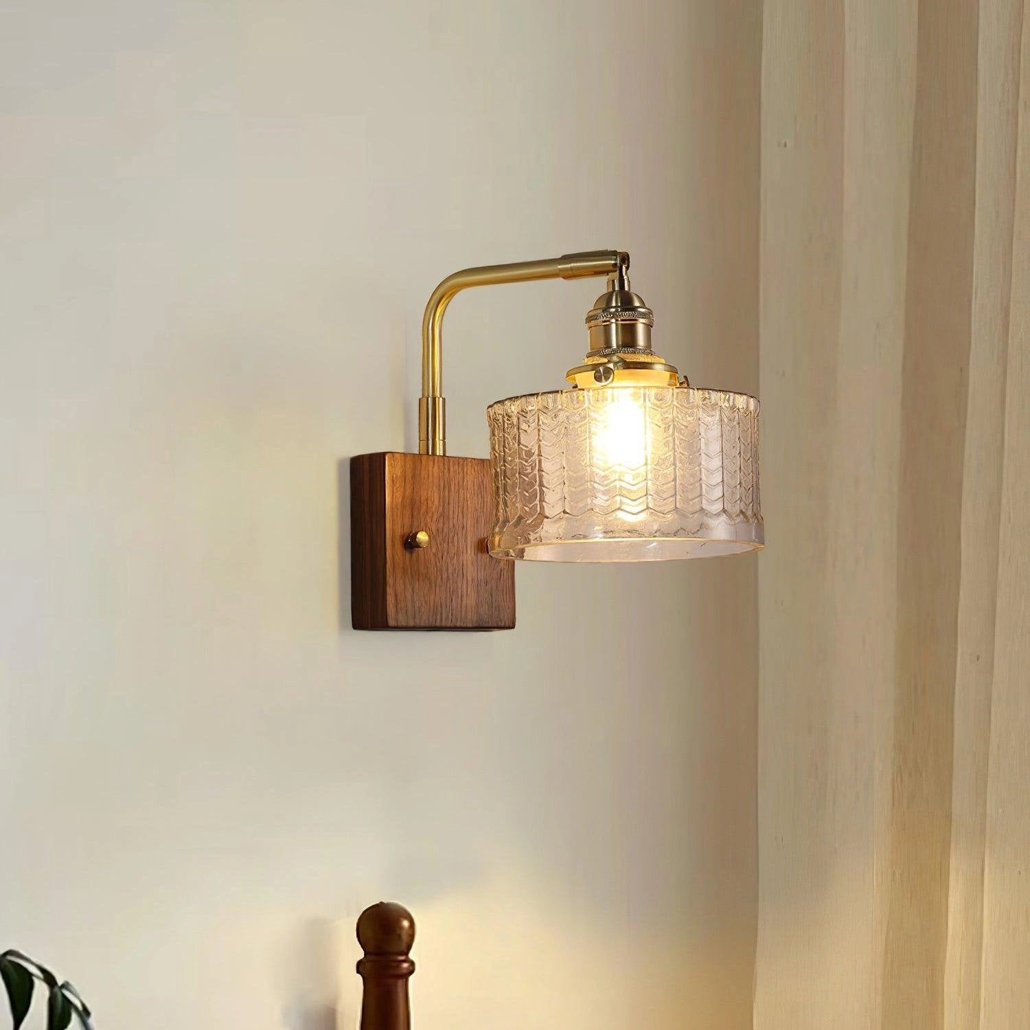Vintage green glass sconce with brass arm featuring a fish scale pattern design, resembling a classic lamp style.