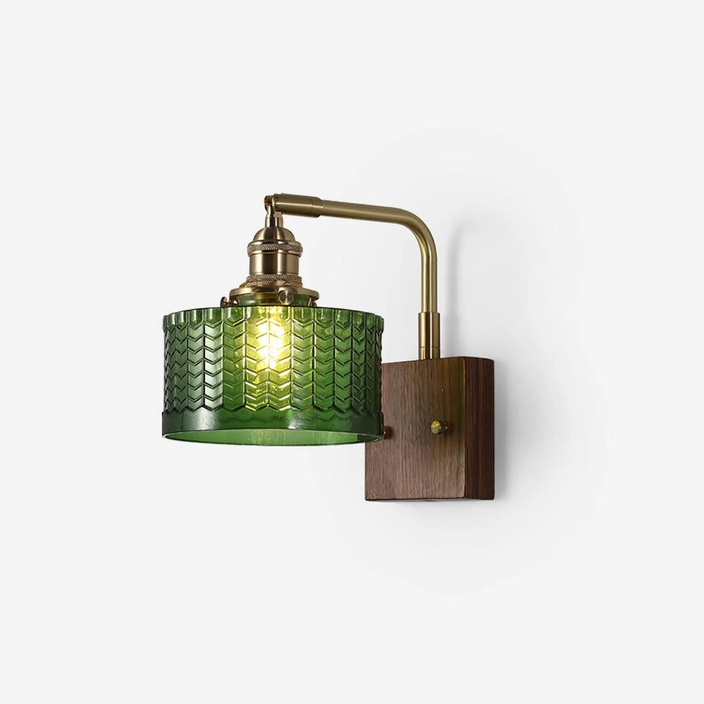 Vintage green glass sconce with a brass arm, featuring a fish scale pattern design.