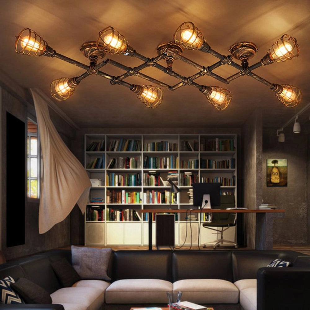 Vintage industrial ceiling light with adjustable track heads in rustic bronze finish, illuminating a living space with a couch, bookcase, and picture frames, showcasing an interior design aesthetic.