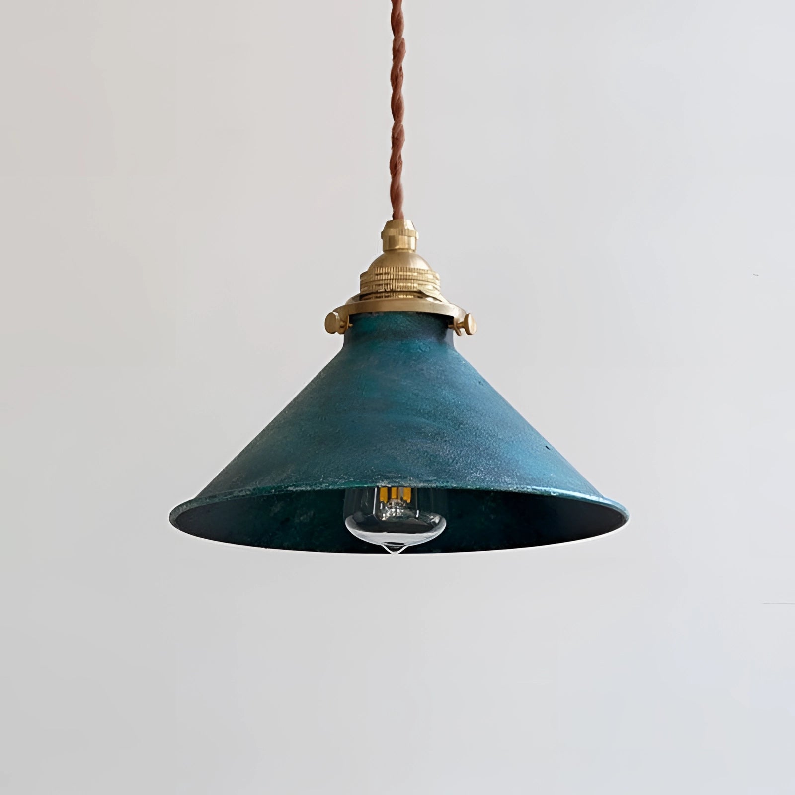 Vintage industrial pendant light in antique brass and distressed blue with a cone-shaped shade, measuring 8.3 inches, featuring metallic finishes and a decorative finial.